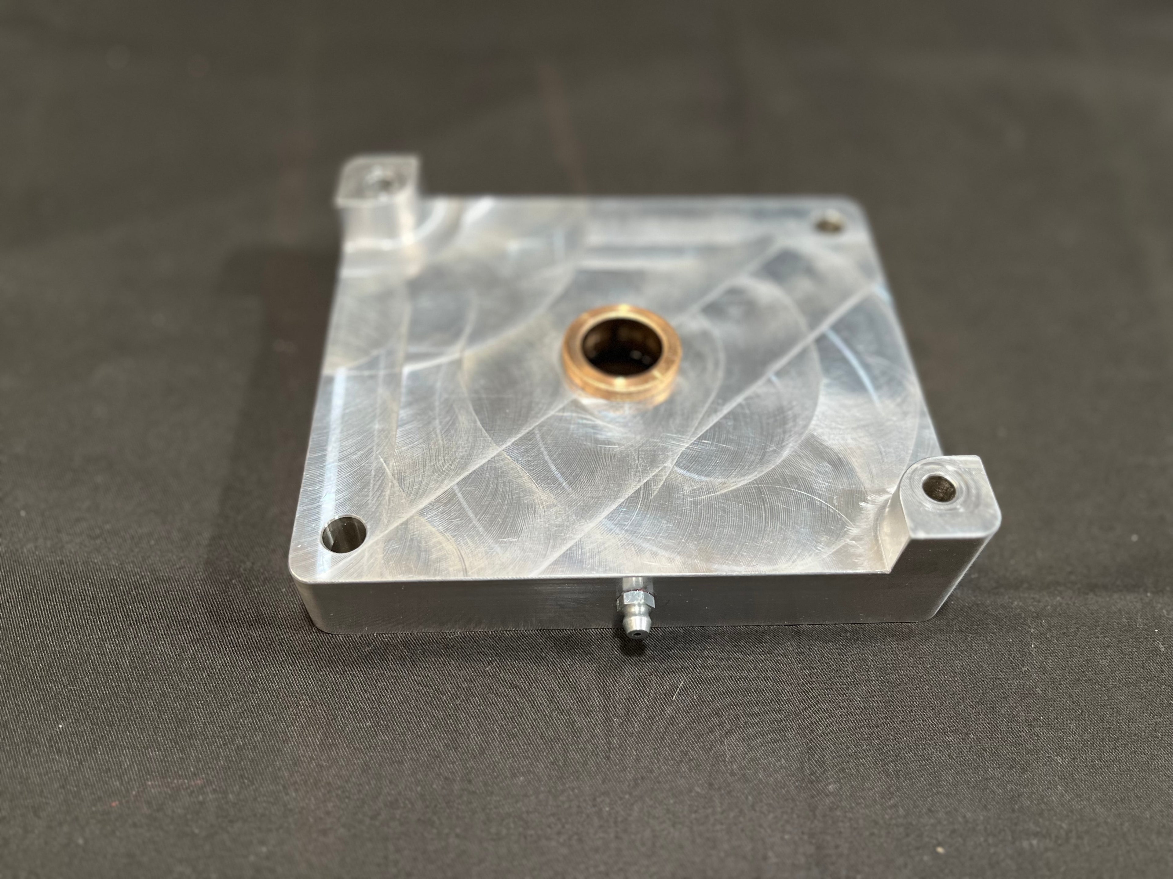 Metal mounting block on gray surface