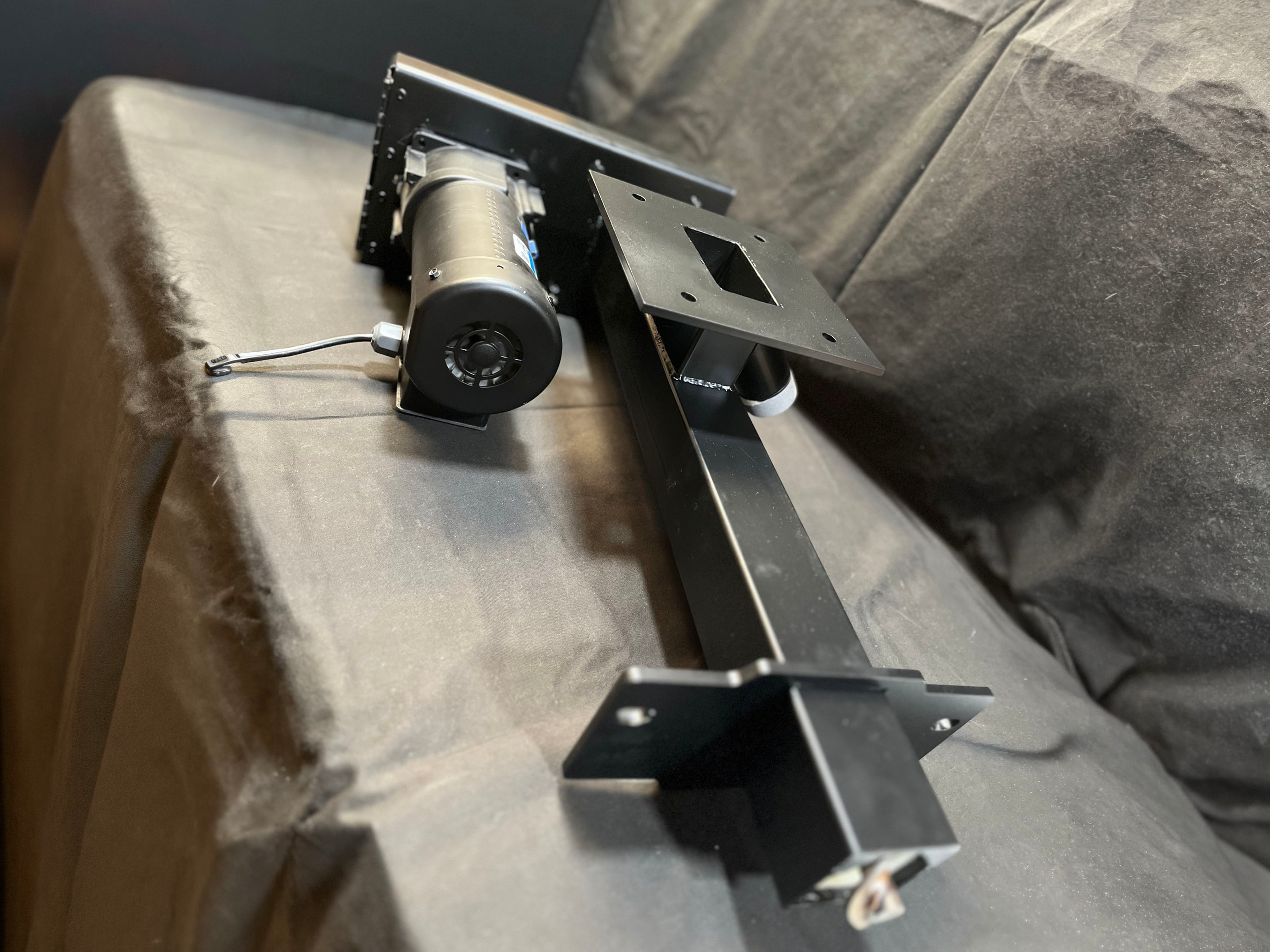 AccuFeeer - Metal bracket or support structure on a textured surface