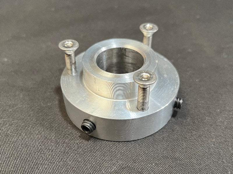 Metal component with threaded holes on a gray background