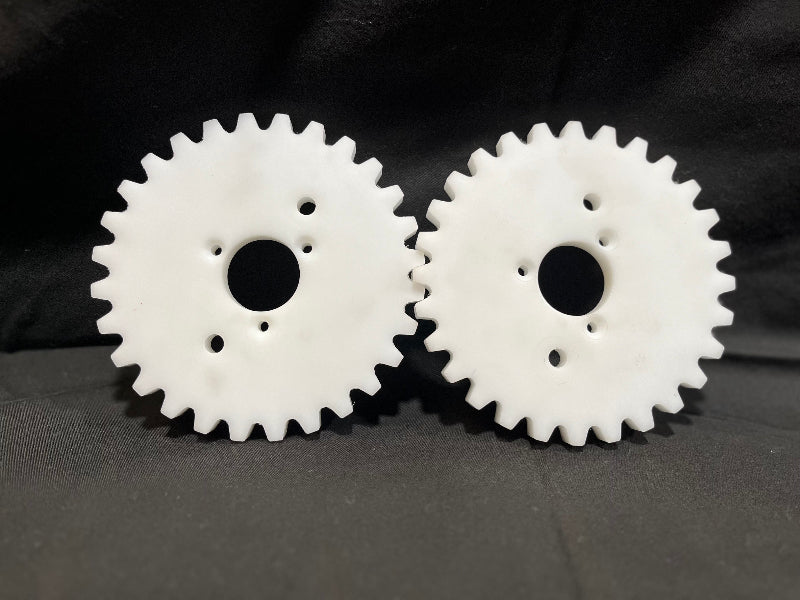 Two white gears on a black background